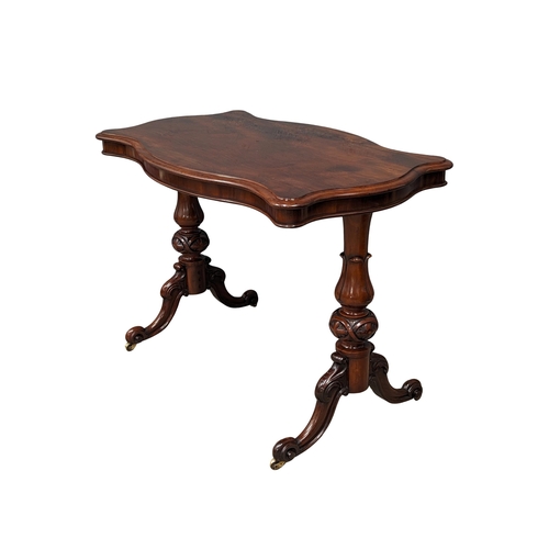 1137 - A Victorian mahogany library table with serpentine top and turn supports on cabriole legs. Circa 186... 