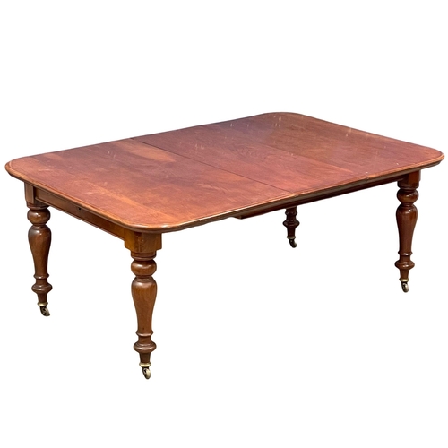 1143 - A Victorian mahogany wind out dining table with leaf and winder. 180x126x73cm(11)