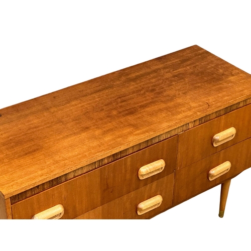 1145 - A Mid Century teak compact sideboard. 107x41x64cm(1)