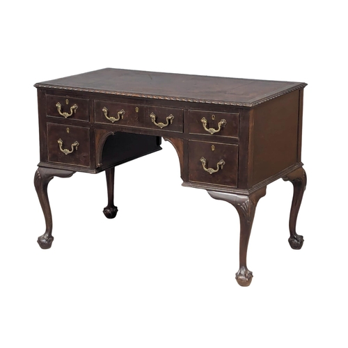 1151 - A good quality early 20th century Chippendale Revival mahogany writing desk with leather top on ball... 