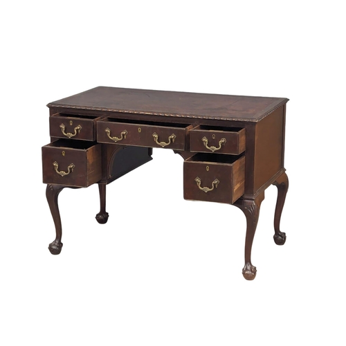 1151 - A good quality early 20th century Chippendale Revival mahogany writing desk with leather top on ball... 