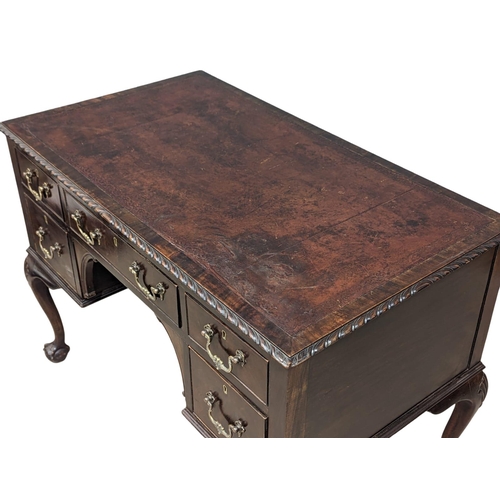 1151 - A good quality early 20th century Chippendale Revival mahogany writing desk with leather top on ball... 