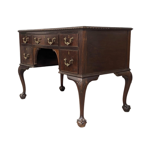 1151 - A good quality early 20th century Chippendale Revival mahogany writing desk with leather top on ball... 