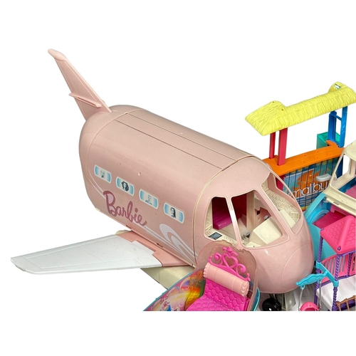 700 - A large collection of Barbie figure and accessories. Barbie airplane, Barbie cars, Barbie speedboat,... 