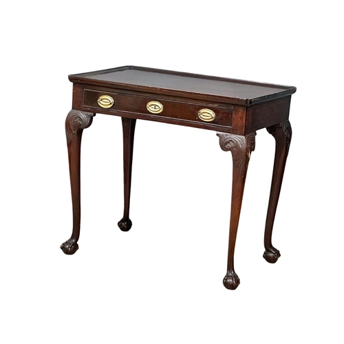 821 - A mid 19th century Irish Chippendale Revival mahogany silver table with drawer on Ball & Claw feet. ... 