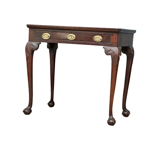 821 - A mid 19th century Irish Chippendale Revival mahogany silver table with drawer on Ball & Claw feet. ... 