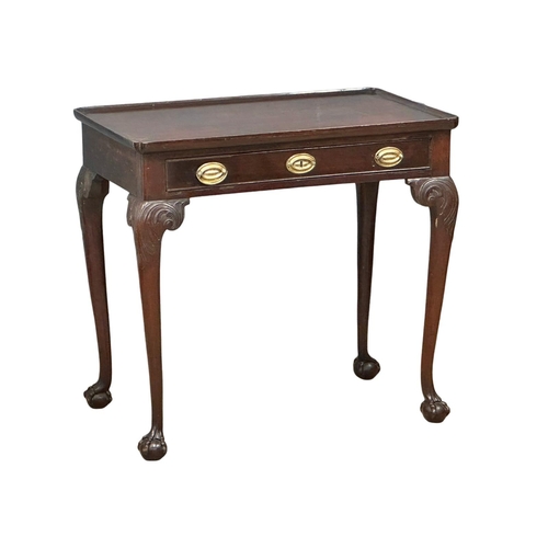 821 - A mid 19th century Irish Chippendale Revival mahogany silver table with drawer on Ball & Claw feet. ... 