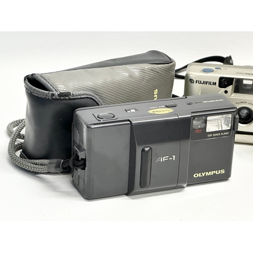 607 - 3 cameras. An Olympus AF-1 camera with case. A Hanimex 35HF camera with case. A Fujifilm Nexia 70AF ... 