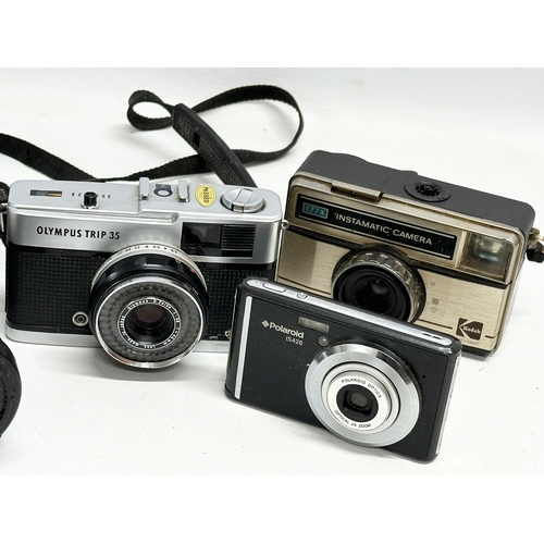 607A - 4 cameras. An Olympus IS-300 camera. An Olympus Trip 35 camera etc.