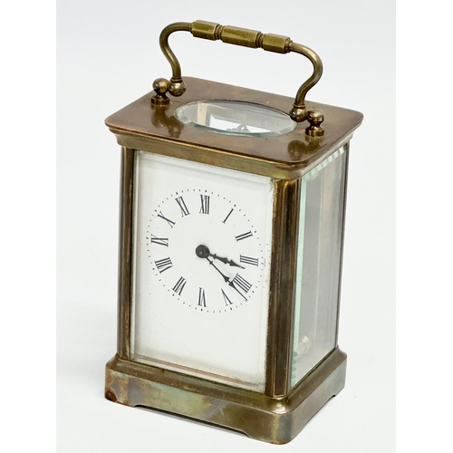 11 - A late 19th century brass carriage clock with case.