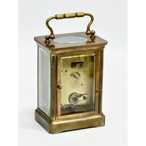 11 - A late 19th century brass carriage clock with case.