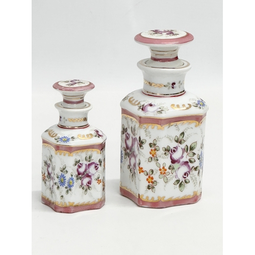 69 - A pair of late 19th century French hand painted porcelain vanity jars/perfume bottles. Largest 14cm.... 