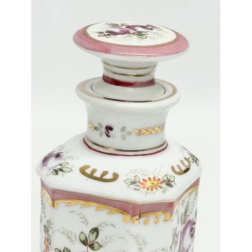 69 - A pair of late 19th century French hand painted porcelain vanity jars/perfume bottles. Largest 14cm.... 