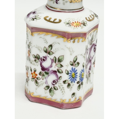 69 - A pair of late 19th century French hand painted porcelain vanity jars/perfume bottles. Largest 14cm.... 