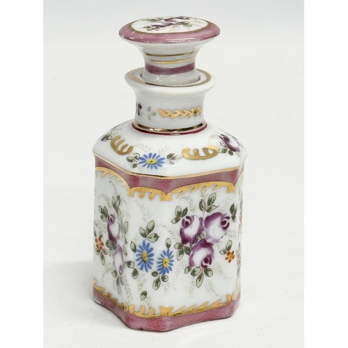 69 - A pair of late 19th century French hand painted porcelain vanity jars/perfume bottles. Largest 14cm.... 