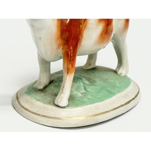 21 - A mid 19th century Victorian Staffordshire pottery Cow Creamer. 16.5x10.5cm