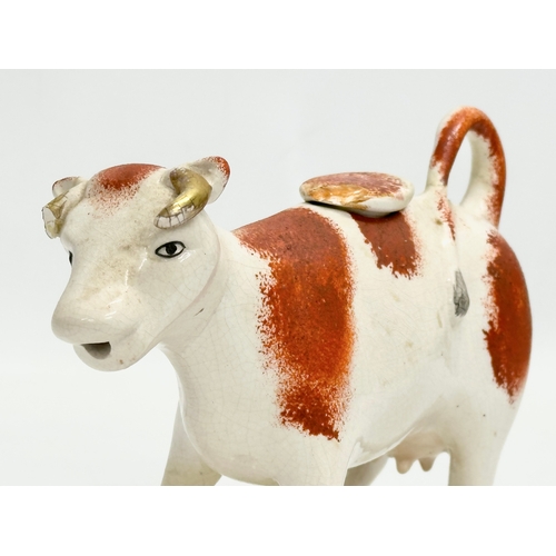 22 - A late 19th century Victorian Staffordshire pottery Cow Creamer. 16x13cm