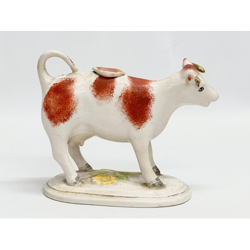 22 - A late 19th century Victorian Staffordshire pottery Cow Creamer. 16x13cm