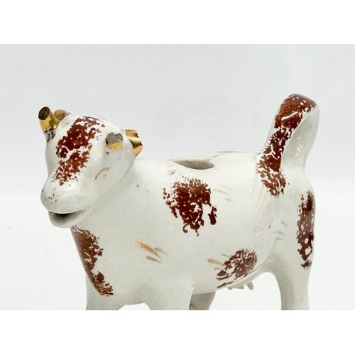 23 - A early/mid 19th century Staffordshire Pottery Cow Creamer. 16x11cm