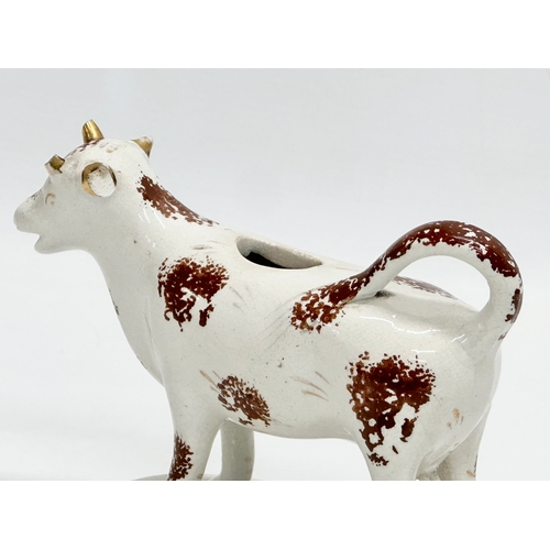 23 - A early/mid 19th century Staffordshire Pottery Cow Creamer. 16x11cm