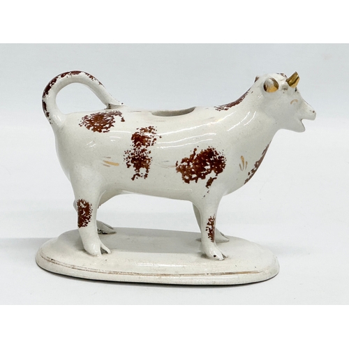 23 - A early/mid 19th century Staffordshire Pottery Cow Creamer. 16x11cm