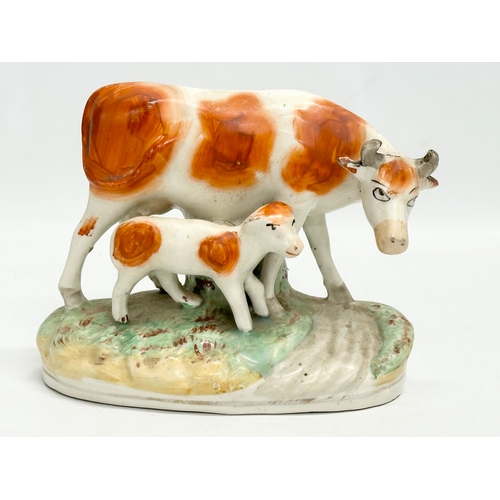 24 - 2 19th century Victorian Staffordshire cows. 21x21.5cm