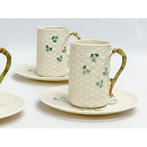 29 - An 8 piece Belleek ‘Shamrock’ coffee service. 1 green stamp mug and 7 brown stamps. Saucers measure ... 