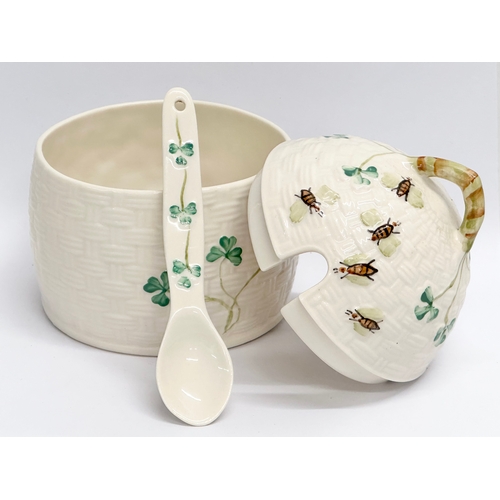 390 - A Belleek Millennium ‘Shamrock’ honey pot with spoon and cover. 9.5x12cm