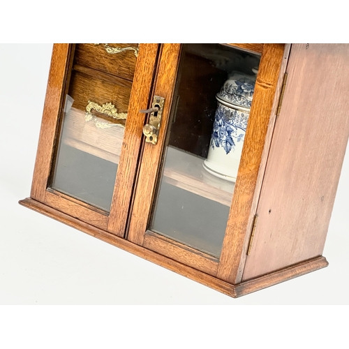 84 - A late Victorian oak humidor. 28.5x18x41.5cm