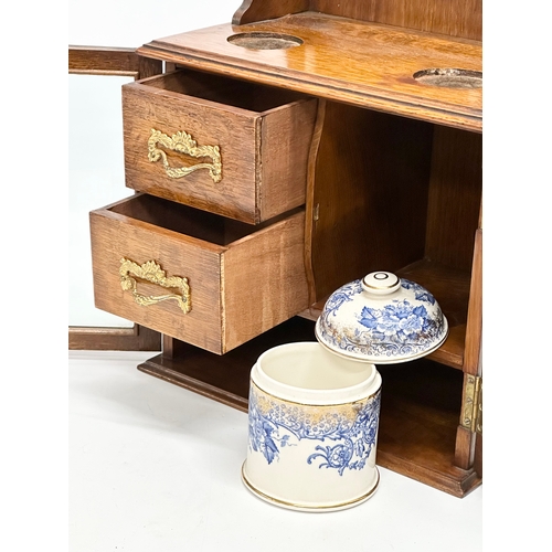 84 - A late Victorian oak humidor. 28.5x18x41.5cm