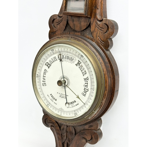 86 - An Edwardian carved oak barometer. R.A.Browne Optician, Belfast. 72cm