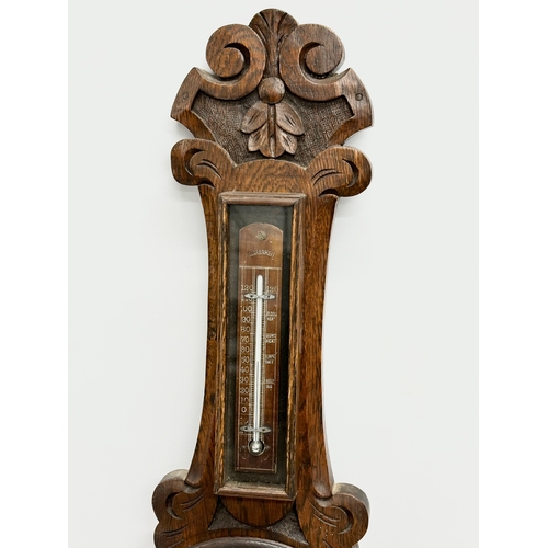 86 - An Edwardian carved oak barometer. R.A.Browne Optician, Belfast. 72cm