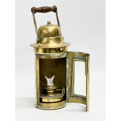 89 - An early 20th century Sherwood Limited brass ships lamp. 26cm including handle.