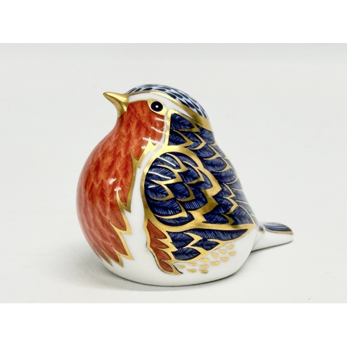 374 - A Royal Crown Derby porcelain robin paperweight. An Mdina Seahorse paperweight and a 1968 West Germa... 