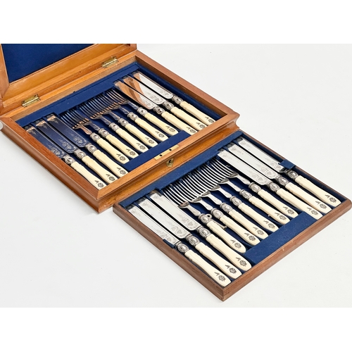 118 - An early 20th century silver plated cutlery set with bone handles in mahogany case. 29x26cm