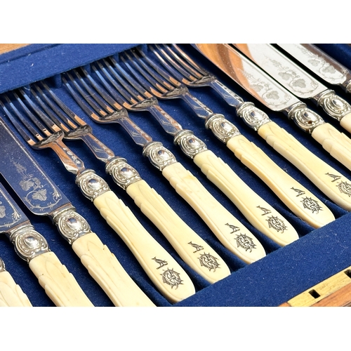 118 - An early 20th century silver plated cutlery set with bone handles in mahogany case. 29x26cm