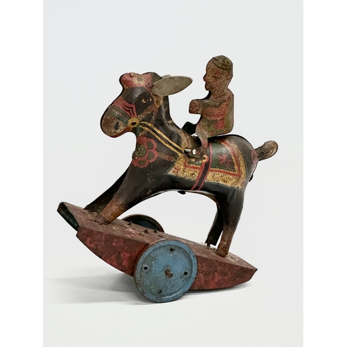 434 - A vintage ‘Peter Pan’ series Stubborn mechanical rocking clown on horse. 15x17cm