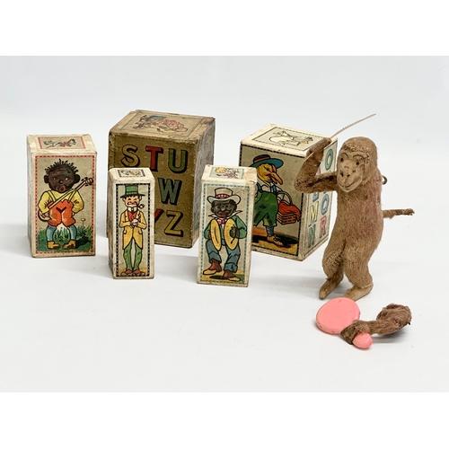 435 - Vintage German toys. A Jolly Jacko windup grooming monkey. Vintage German child’s building blocks.