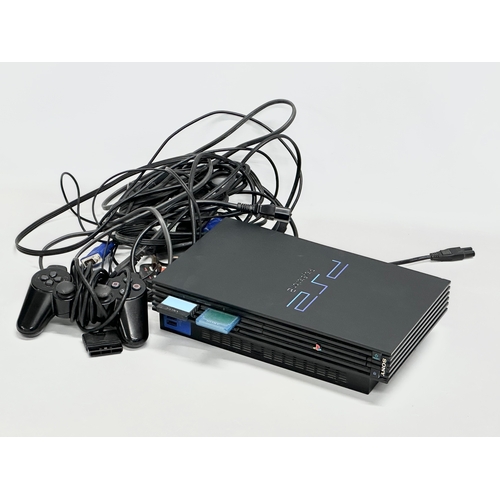 439 - A PlayStation 2 with controller and leads.