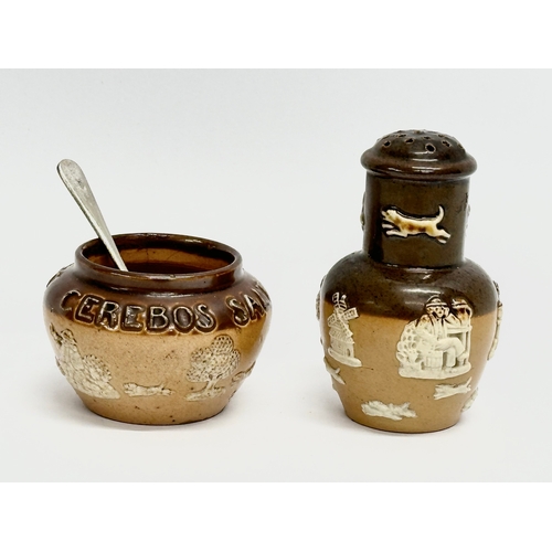 429 - An early 20th century Royal Doulton Lambeth 2 piece condiment set. Salt and pepper shaker.