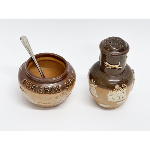 429 - An early 20th century Royal Doulton Lambeth 2 piece condiment set. Salt and pepper shaker.