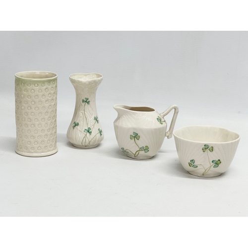 658 - A collection of pottery. A pair of 4th period Belleek pottery sunflower trumpet vases 19.5cm. A larg... 