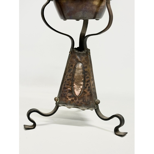 104 - A late 19th century Arts & Crafts copper and wrought iron oil lamp. 24x68cm