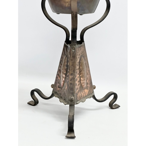 104 - A late 19th century Arts & Crafts copper and wrought iron oil lamp. 24x68cm