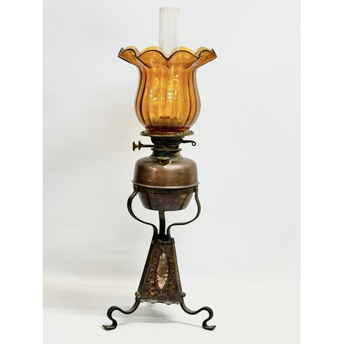 104 - A late 19th century Arts & Crafts copper and wrought iron oil lamp. 24x68cm