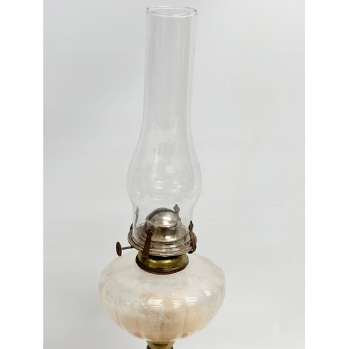 445 - An early 20th century oil lamp with copper and brass column. 60cm