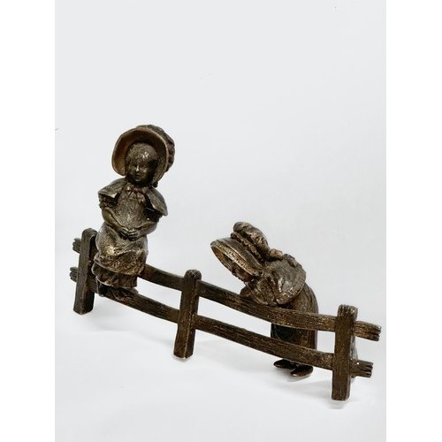 262 - A bronze ‘Two Little Girls Sitting’ figurine. 16x8cm