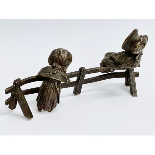 262 - A bronze ‘Two Little Girls Sitting’ figurine. 16x8cm