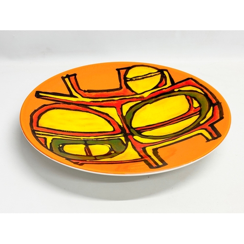 361 - A large Poole Pottery ‘Delphis’ charger/bowl designed by Carol Cutler. 41x6cm