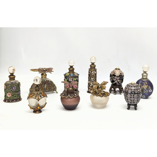 472 - A collection of ornate scent bottles / perfume bottles.